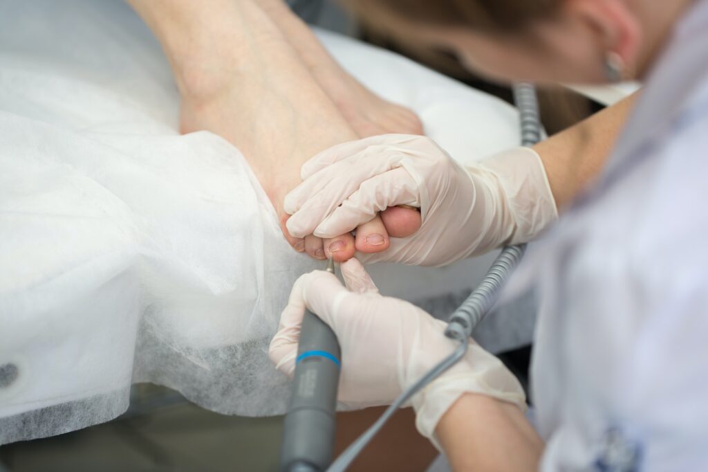 Professional pedicure master making pedicure in salon